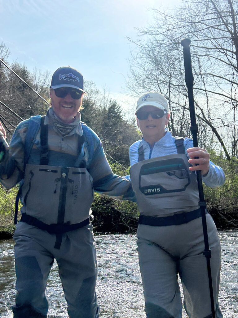 Fly fishing guide helping any angler cross the Battenkill River in Southern Vermont